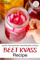 Holding up a glass jar of beet kvass with ice cubes. Text overlay says: "Beet Kvass Recipe (plus flavor ideas!)"