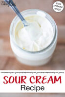 Thickened homemade sour cream in a glass jar. Text overlay says: "Sour Cream Recipe (thick probiotic tangy)"