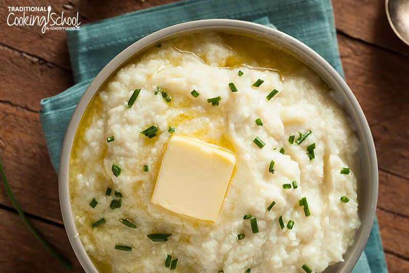 Mashed cauliflower with chives and butter melting atop.