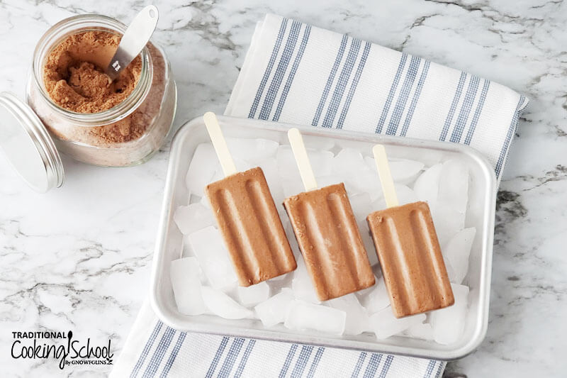 Homemade dairy-free fudge pops on ice.