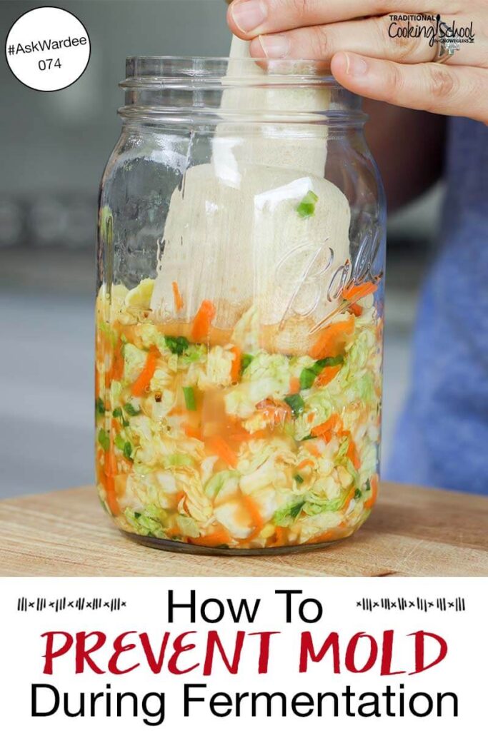 Woman's hand using a wooden kraut pounder to press kimchi into a glass jar. Text overlay says: "How to Prevent Mold During Fermentation #AskWardee 074"