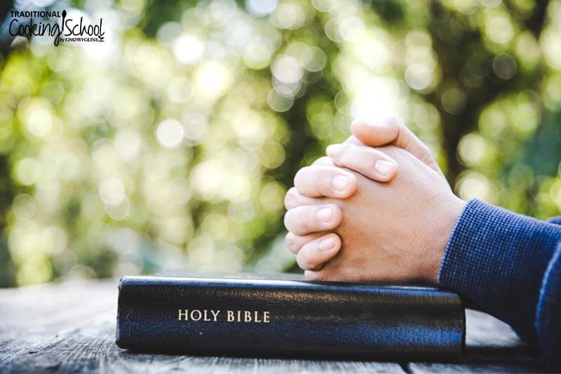 Person's hands clasped on top of a leather-bound Bible, illustrating praying for God's help when we're sick even if we eat healthy.