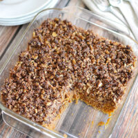 Sweet potato casserole with a crumble topping in a glass casserole dish