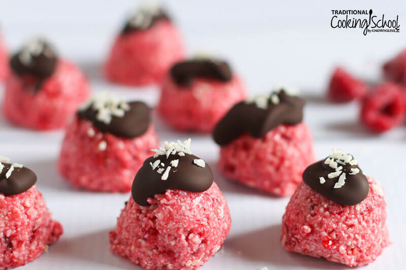 No-bake raspberry bites topped with chocolate and a sprinkle of shredded coconut.