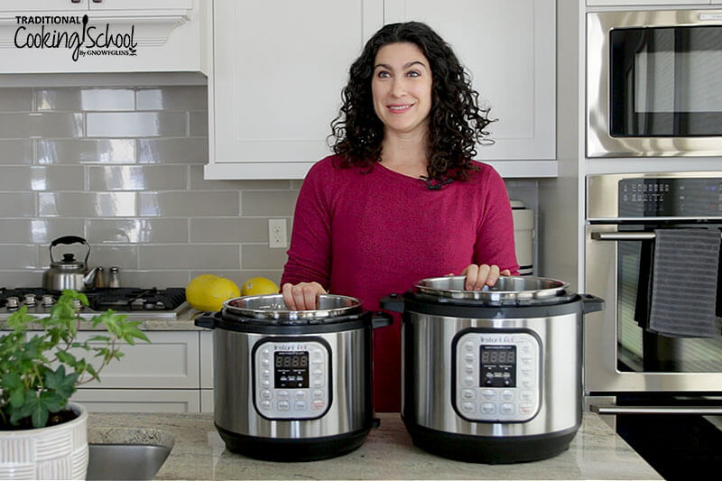 A smiling woman in her kitchen with two Instant Pots in front of her on the counter.